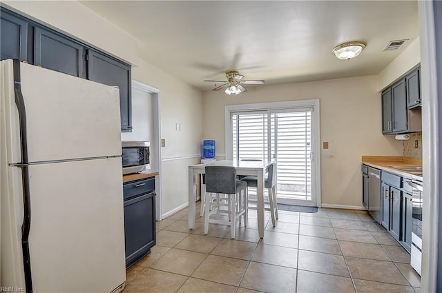 2561 Elon Dr, Virginia Beach, VA 23454 - kitchen with appliances with stainless steel finishes, ceiling fan, and light tile patterned floors