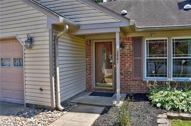 2561 Elon Dr, Virginia Beach, VA 23454 - doorway to property featuring brick siding, a shingled roof, and an attached garage