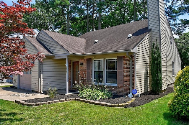 2561 Elon Dr, Virginia Beach, VA 23454 - single story home with a garage, brick siding, a chimney, roof with shingles, and a front yard