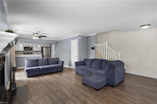 625 Ridge Cir, Chesapeake, VA 23320 - living area featuring a fireplace with flush hearth, dark wood-style floors, stairway, a ceiling fan, and crown molding