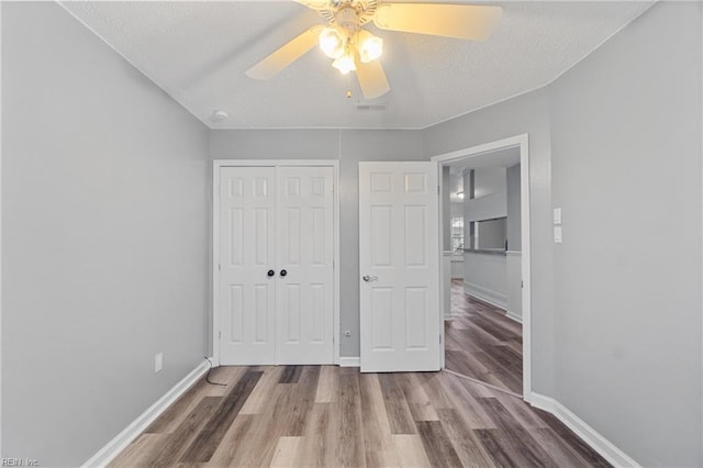 515 Wharf Ct, Virginia Beach, VA 23462 - unfurnished bedroom featuring a closet, wood finished floors, ceiling fan, and a textured ceiling