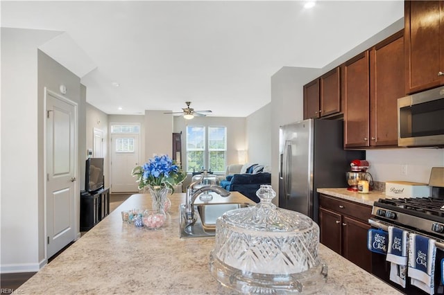 4315 Sconce, Williamsburg, VA 23188 - kitchen with appliances with stainless steel finishes, ceiling fan, open floor plan, light stone countertops, and recessed lighting