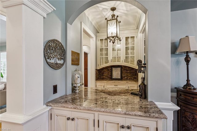 201 Glebe Spring Ln, Yorktown, VA 23693 - bar with arched walkways, a chandelier, crown molding, tasteful backsplash, and hanging light fixtures