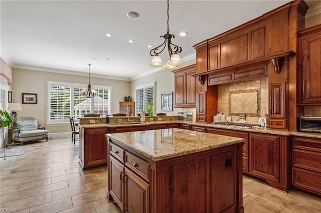 201 Glebe Spring Ln, Yorktown, VA 23693 - kitchen featuring a chandelier, a peninsula, decorative backsplash, a kitchen island, and crown molding