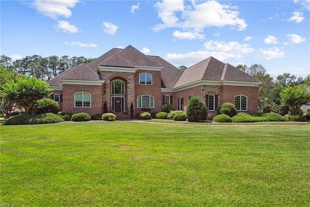 201 Glebe Spring Ln, Yorktown, VA 23693 - view of front of house with a front lawn, brick siding, and roof with shingles