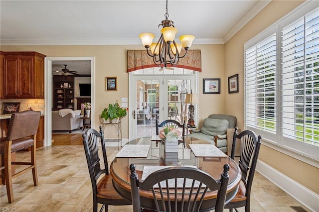 201 Glebe Spring Ln, Yorktown, VA 23693 - dining area with a chandelier, ornamental molding, ceiling fan, french doors, and light stone finish floors