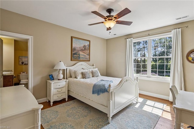 201 Glebe Spring Ln, Yorktown, VA 23693 - bedroom with wood finished floors, connected bathroom, and ceiling fan