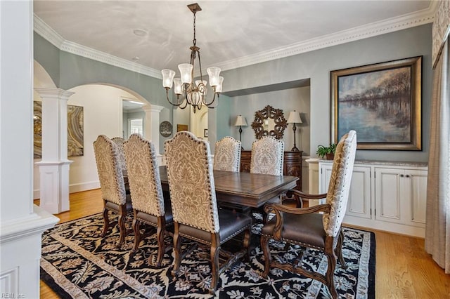 201 Glebe Spring Ln, Yorktown, VA 23693 - dining area with decorative columns, arched walkways, a chandelier, light wood-style floors, and ornamental molding