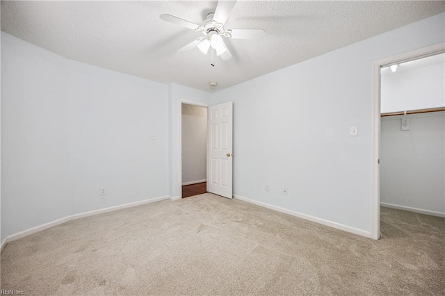 563 Seahorse Run, Chesapeake, VA 23320 - unfurnished bedroom with carpet floors, a walk in closet, a textured ceiling, and a closet