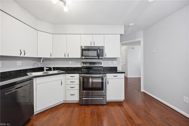 563 Seahorse Run, Chesapeake, VA 23320 - kitchen with stainless steel appliances, white cabinetry, dark countertops, and dark wood-style floors