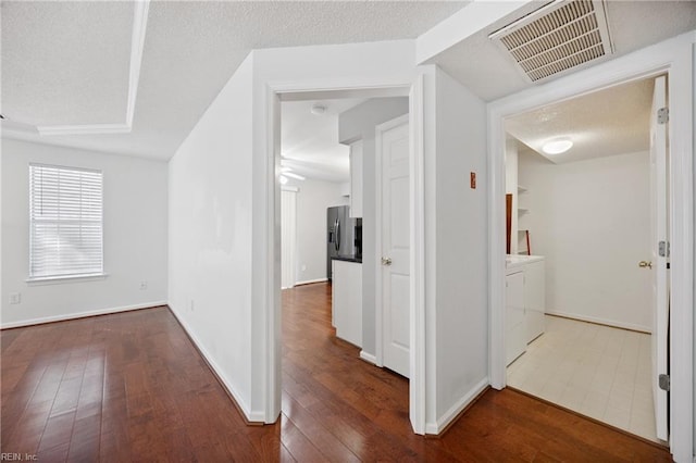 563 Seahorse Run, Chesapeake, VA 23320 - hall featuring washing machine and clothes dryer, hardwood / wood-style floors, and a textured ceiling