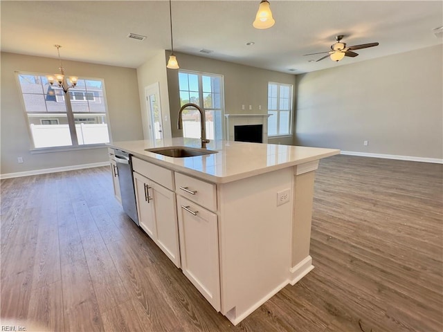 4472 Old Princess Anne Rd, Virginia Beach, VA 23462 - kitchen featuring dishwasher, open floor plan, a chandelier, white cabinetry, and a fireplace