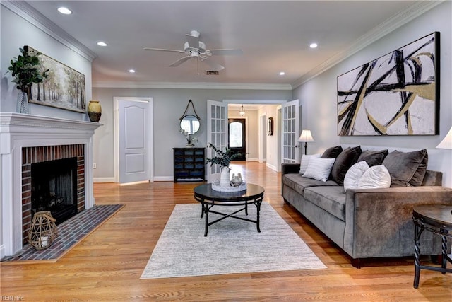 66 Heron Harbor Way, Hudgins, VA 23076 - living area with light wood-style flooring, ceiling fan, recessed lighting, ornamental molding, and a fireplace