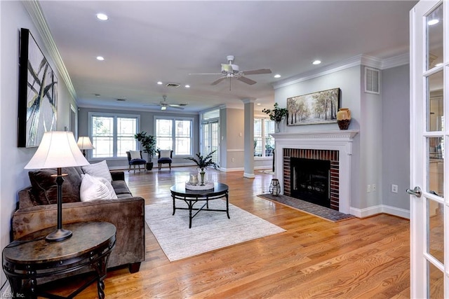 66 Heron Harbor Way, Hudgins, VA 23076 - living area with crown molding, ceiling fan, recessed lighting, a brick fireplace, and wood finished floors
