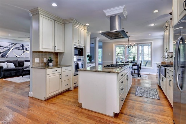 66 Heron Harbor Way, Hudgins, VA 23076 - kitchen featuring a center island, island exhaust hood, light wood-style flooring, healthy amount of natural light, and recessed lighting