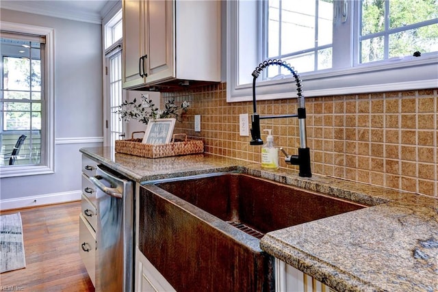 66 Heron Harbor Way, Hudgins, VA 23076 - kitchen with crown molding, wood finished floors, backsplash, stainless steel dishwasher, and stone countertops
