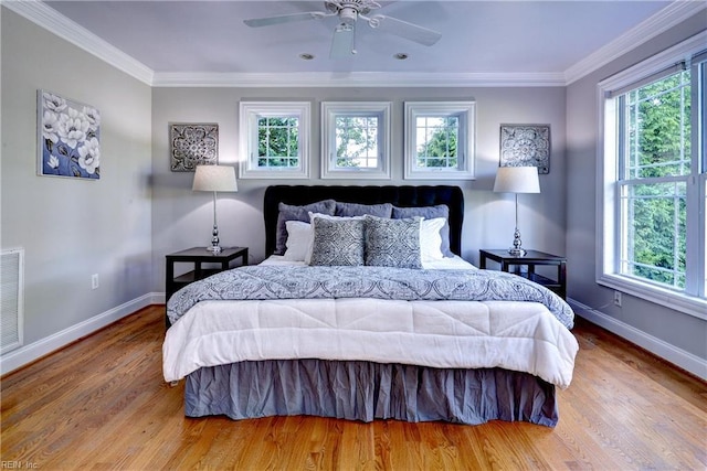 66 Heron Harbor Way, Hudgins, VA 23076 - bedroom featuring multiple windows, wood finished floors, ornamental molding, and a ceiling fan