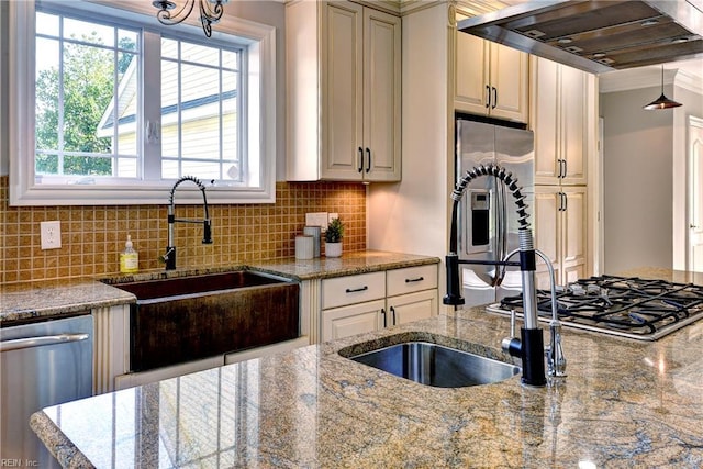 66 Heron Harbor Way, Hudgins, VA 23076 - kitchen with under cabinet range hood, stainless steel appliances, decorative backsplash, stone counters, and cream cabinets