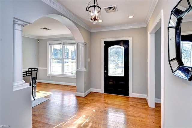 66 Heron Harbor Way, Hudgins, VA 23076 - foyer entrance with arched walkways, ornate columns, wood finished floors, ornamental molding, and a chandelier