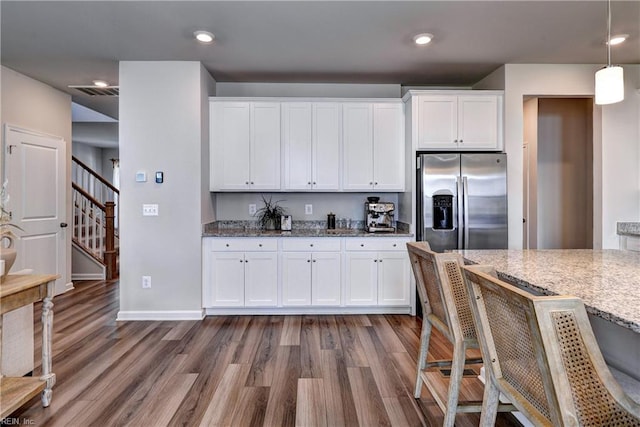 9116 Daydreamer Ct, Toano, VA 23168 - kitchen featuring stainless steel refrigerator with ice dispenser, dark wood-style flooring, light stone countertops, white cabinetry, and recessed lighting