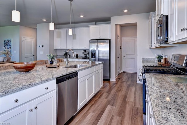 9116 Daydreamer Ct, Toano, VA 23168 - kitchen with stainless steel appliances, white cabinetry, wood finished floors, pendant lighting, and recessed lighting