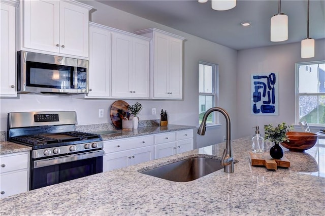 9116 Daydreamer Ct, Toano, VA 23168 - kitchen with stainless steel appliances, white cabinetry, light stone counters, hanging light fixtures, and recessed lighting
