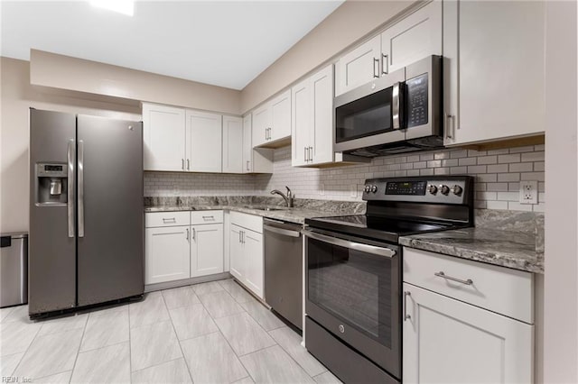 37 Winster Fax, Williamsburg, VA 23185 - kitchen with appliances with stainless steel finishes, backsplash, white cabinets, and dark stone countertops