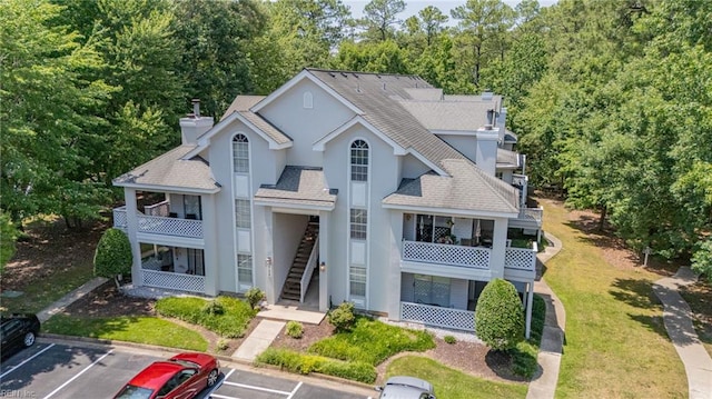 708 Inlet Quay Quay Unit D, Chesapeake, VA 23320 - view of front of home with a balcony, uncovered parking, stucco siding, and a shingled roof
