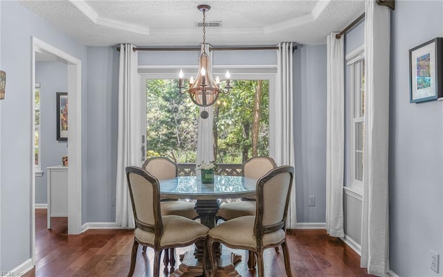 708 Inlet Quay Quay Unit D, Chesapeake, VA 23320 - dining room featuring a chandelier, dark wood-type flooring, a textured ceiling, a raised ceiling, and ornamental molding