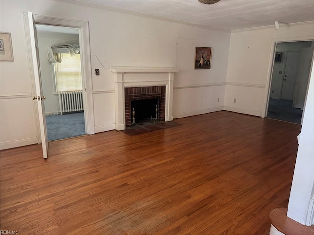 44 Milford Rd, Newport News, VA 23601 - unfurnished living room featuring radiator heating unit, crown molding, wood finished floors, and a brick fireplace