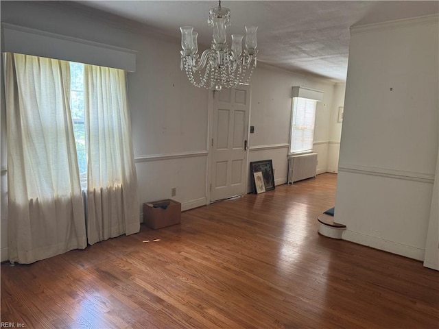 44 Milford Rd, Newport News, VA 23601 - unfurnished dining area with radiator heating unit, ornamental molding, wood finished floors, and a chandelier