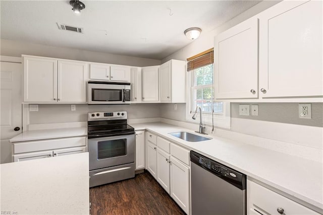 201 Jarvis Rd, Chesapeake, VA 23323 - kitchen featuring appliances with stainless steel finishes, white cabinets, dark wood-type flooring, and light countertops