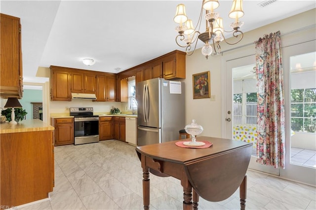 106 Deep Water Cv, Newport News, VA 23606 - kitchen featuring stainless steel appliances, under cabinet range hood, light marble finish floors, and light countertops