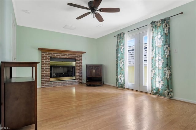 106 Deep Water Cv, Newport News, VA 23606 - unfurnished living room with wood finished floors, a ceiling fan, and a brick fireplace