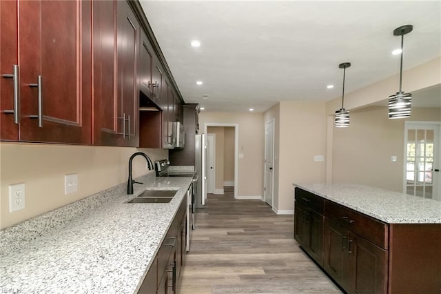 3205 Moat Ln, Chesapeake, VA 23325 - kitchen with recessed lighting, light wood-type flooring, a kitchen island, stainless steel appliances, and light stone counters