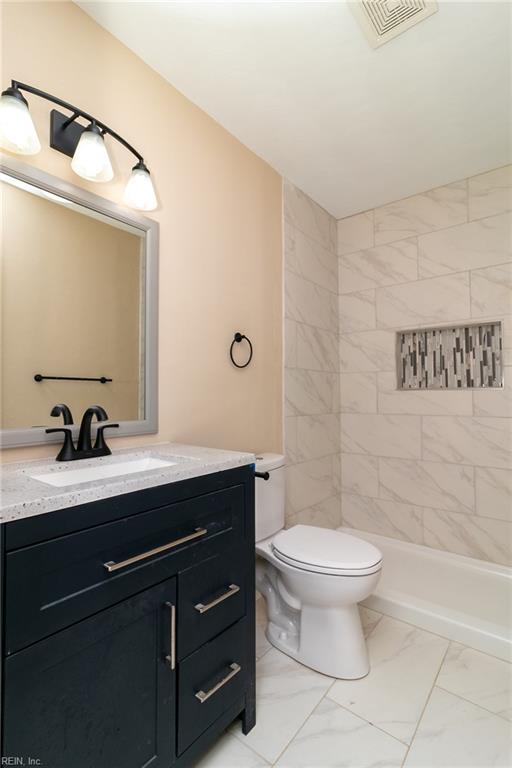 3205 Moat Ln, Chesapeake, VA 23325 - bathroom featuring marble look tiles, vanity, and tiled shower