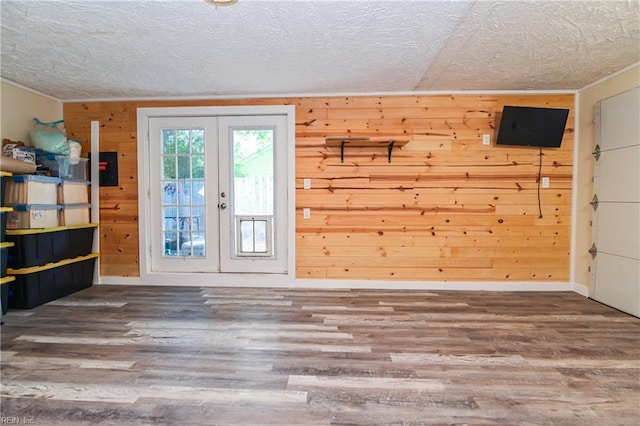 2813 Squire Ct, Chesapeake, VA 23323 - foyer featuring a textured ceiling, french doors, wooden walls, wood finished floors, and ornamental molding