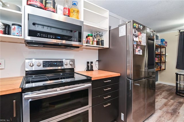 2813 Squire Ct, Chesapeake, VA 23323 - kitchen featuring appliances with stainless steel finishes, butcher block counters, open shelves, dark cabinets, and wood finished floors