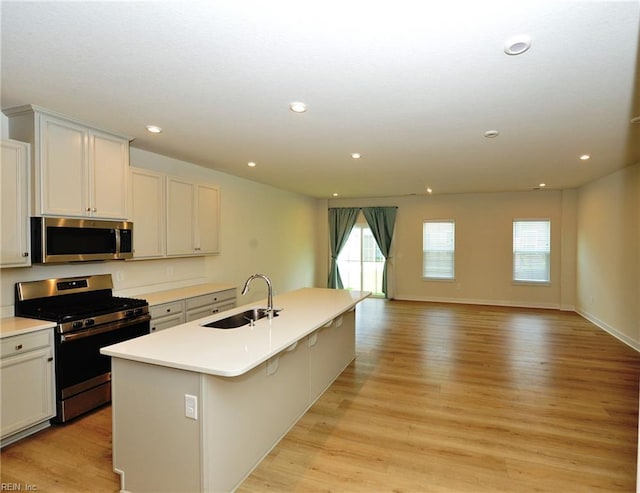 1604 Redwing Arch, Chesapeake, VA 23323 - kitchen featuring stainless steel appliances, light wood-style floors, an island with sink, light countertops, and recessed lighting