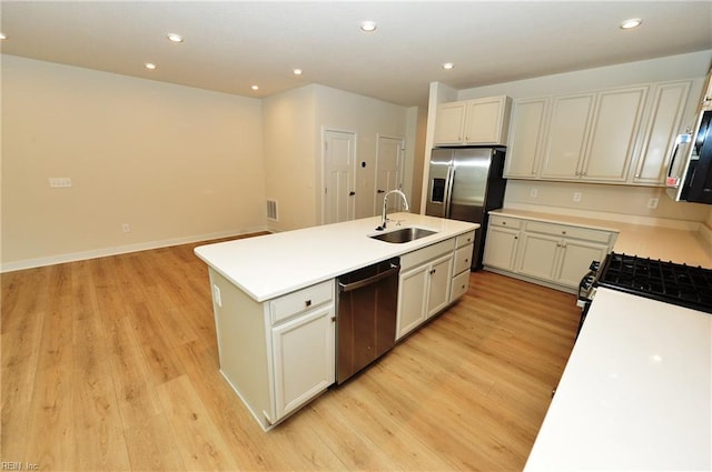 1604 Redwing Arch, Chesapeake, VA 23323 - kitchen featuring stainless steel appliances, a kitchen island with sink, light wood finished floors, recessed lighting, and light countertops
