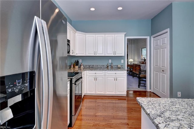 2712 Holly Ridge Ln, Williamsburg, VA 23185 - kitchen featuring stainless steel appliances, light wood-type flooring, white cabinetry, light stone countertops, and recessed lighting