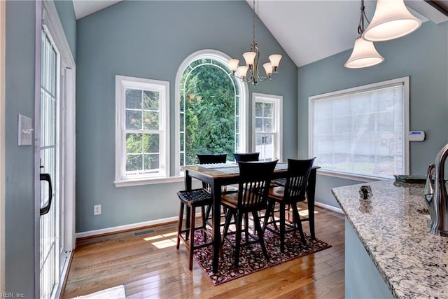 2712 Holly Ridge Ln, Williamsburg, VA 23185 - dining room with vaulted ceiling, wood finished floors, and a chandelier