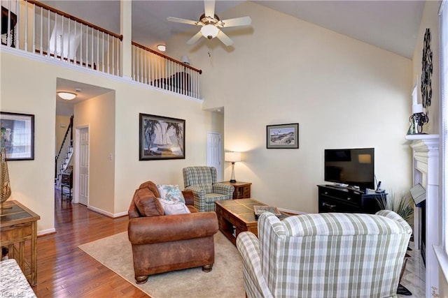 2712 Holly Ridge Ln, Williamsburg, VA 23185 - living room with a high ceiling, wood finished floors, a ceiling fan, and a fireplace