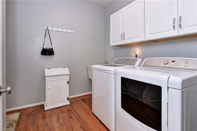 2712 Holly Ridge Ln, Williamsburg, VA 23185 - laundry room featuring washing machine and dryer, light wood-style flooring, and cabinet space