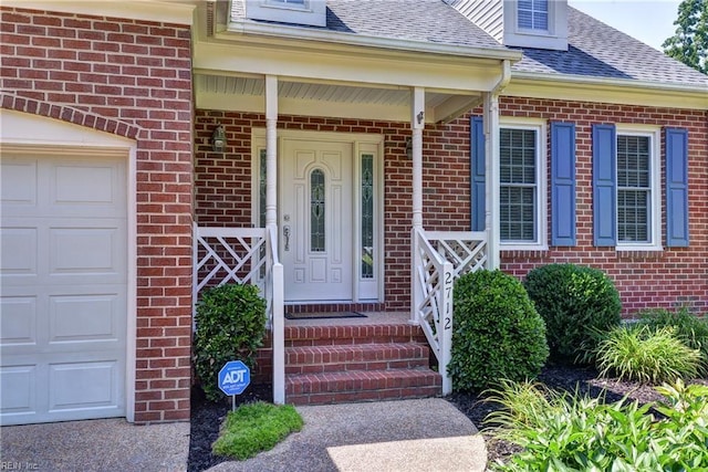 2712 Holly Ridge Ln, Williamsburg, VA 23185 - entrance to property featuring brick siding, a shingled roof, and an attached garage
