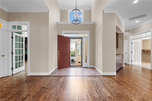 308 Rivers Edge, Williamsburg, VA 23185 - foyer with a chandelier, light wood finished floors, crown molding, and recessed lighting