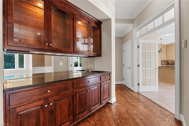 308 Rivers Edge, Williamsburg, VA 23185 - bar with ornamental molding, plenty of natural light, dark wood-style floors, and backsplash