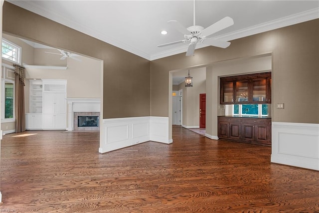 308 Rivers Edge, Williamsburg, VA 23185 - unfurnished living room featuring ceiling fan, wood finished floors, a tile fireplace, crown molding, and wainscoting