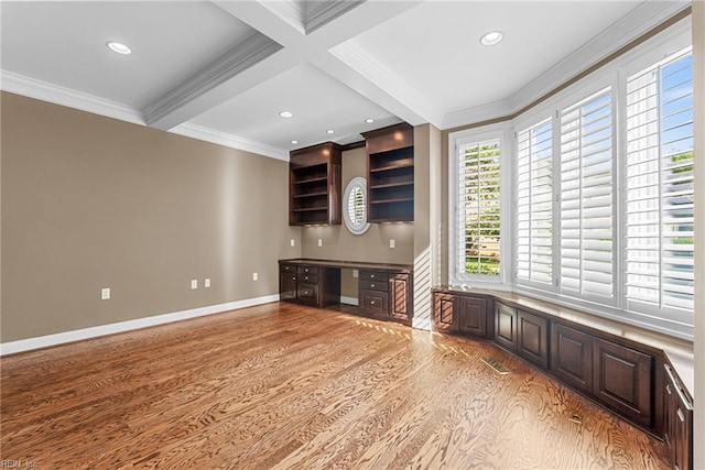 308 Rivers Edge, Williamsburg, VA 23185 - kitchen featuring built in desk, light wood finished floors, beamed ceiling, dark brown cabinetry, and crown molding