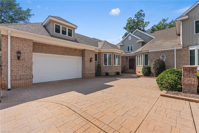 308 Rivers Edge, Williamsburg, VA 23185 - view of front of house featuring brick siding, a garage, decorative driveway, and a shingled roof